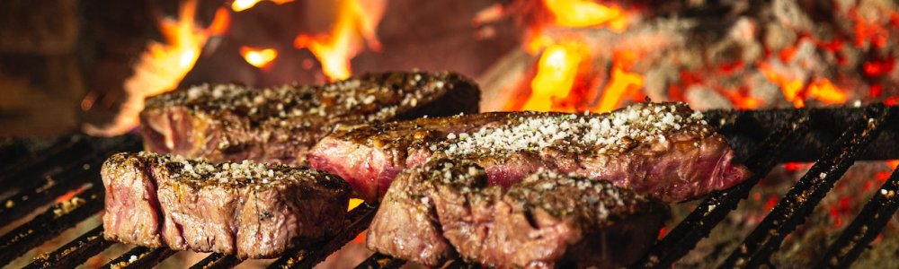 A brick barbecue can stand in a backyard gazebo